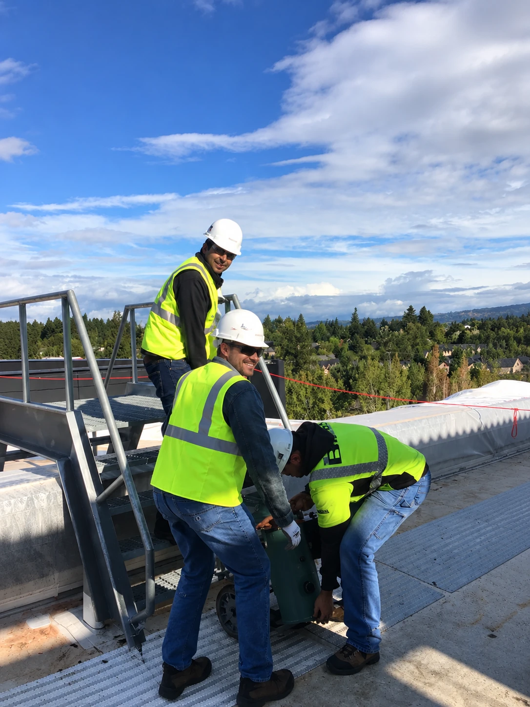 Multidisciplinary team working on rooftop HVAC equipment